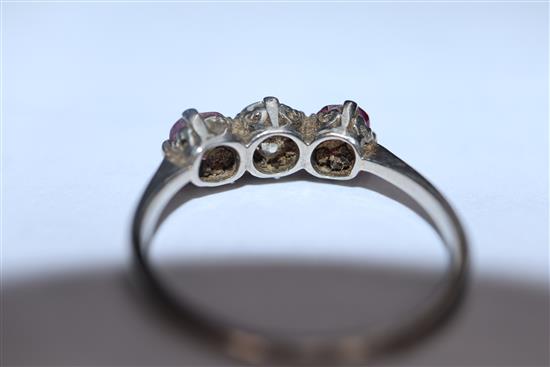 A white metal, ruby and diamond three stone ring, (shank cut).